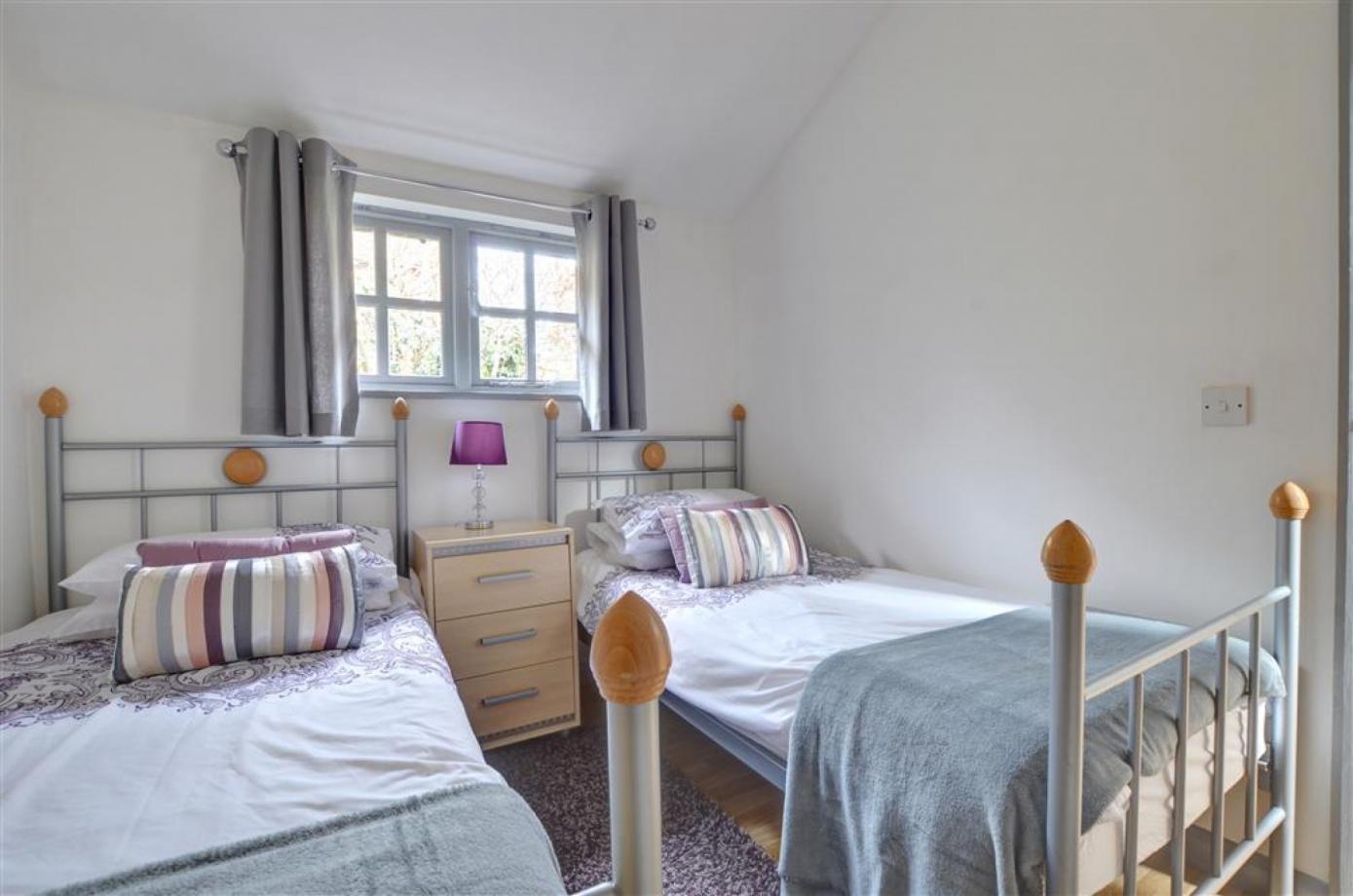 A bedroom with two single beds in one of the Cranbrook Holiday lets for accomodation in Kent..