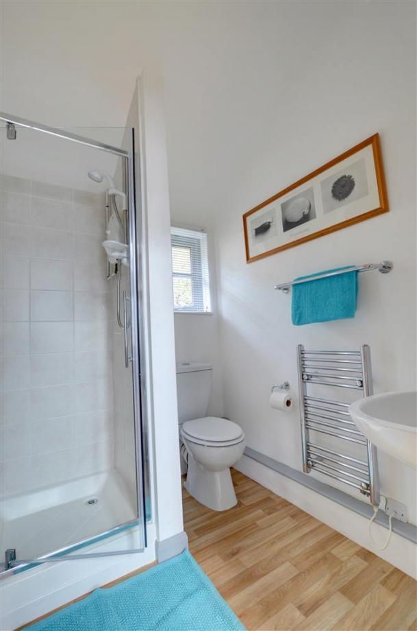 The shower room in one of the apartments in Cranbrook holiday lets shows a shower, toilet and a sink for accomodation in Kent..